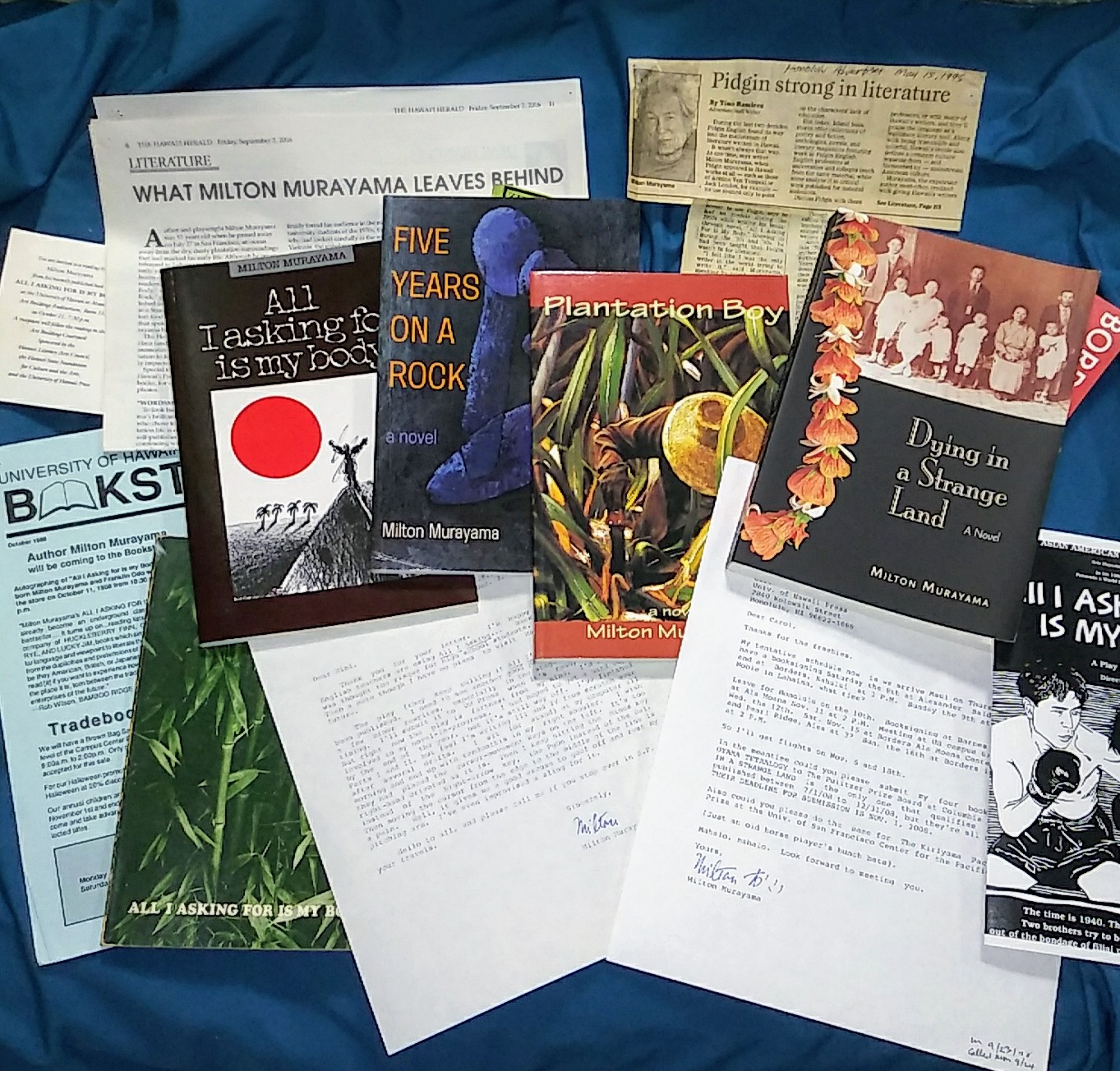 All 5 of Murayama's books, surrounded by clippings and letters
