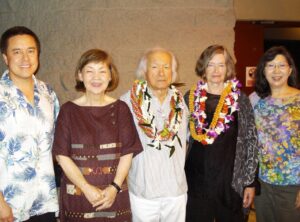 5 people, including Murayama and wife Dawn, wearing lei.