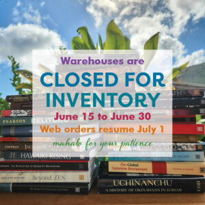 Closed for inventory sign placed on photo of two stacks of books, with ti leaves and blue sky with white clouds behind.
